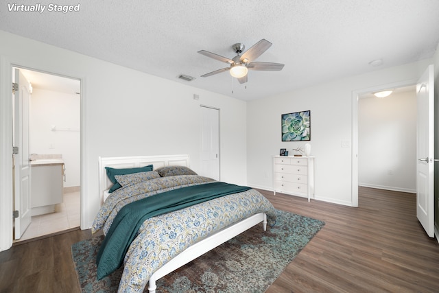 4718 NW 59th Mnr, Coconut Creek, FL 33073 - bedroom with wood finished floors, a textured ceiling, baseboards, ceiling fan, and connected bathroom