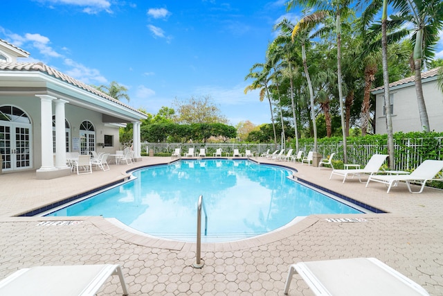 4718 NW 59th Mnr, Coconut Creek, FL 33073 - community pool featuring french doors, a patio area, and fence