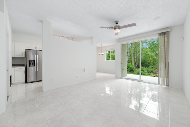 4718 NW 59th Mnr, Coconut Creek, FL 33073 - empty room featuring ceiling fan, a chandelier, a textured ceiling, and light marble finish flooring