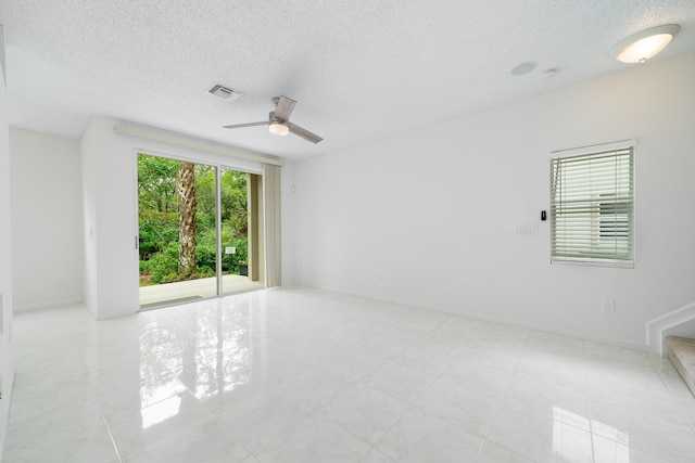 4718 NW 59th Mnr, Coconut Creek, FL 33073 - spare room with a textured ceiling, ceiling fan, stairway, and baseboards
