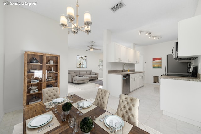 4718 NW 59th Mnr, Coconut Creek, FL 33073 - dining space featuring a chandelier, a ceiling fan, and baseboards