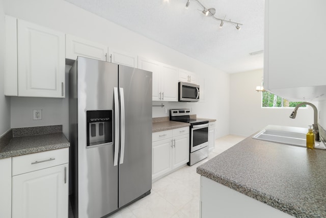 4718 NW 59th Mnr, Coconut Creek, FL 33073 - kitchen featuring appliances with stainless steel finishes, a sink, and white cabinetry