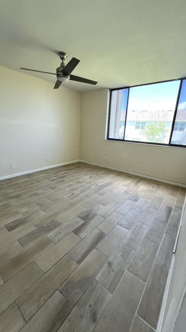 4345 Trevi Ct Unit 208, Lake Worth, FL 33467 - unfurnished room with wood finish floors, a ceiling fan, and baseboards