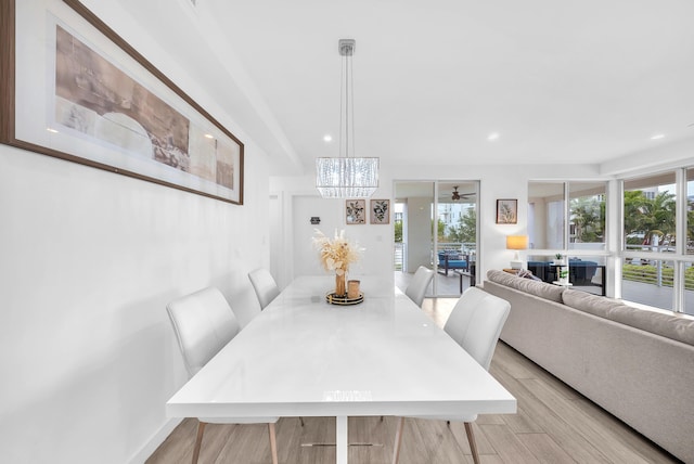 dining area with light wood finished floors, a chandelier, and recessed lighting
