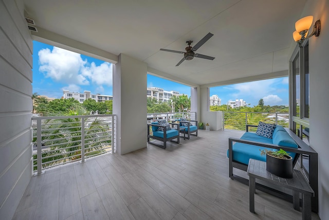 view of patio featuring ceiling fan, an outdoor hangout area, and a balcony