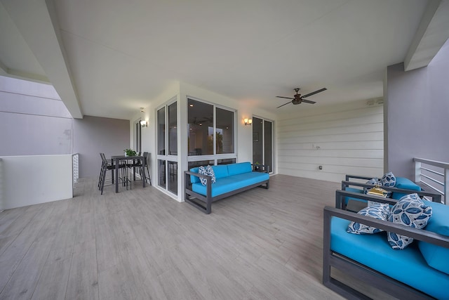 wooden terrace with ceiling fan and an outdoor hangout area