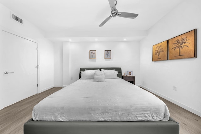 bedroom with wood finished floors, recessed lighting, a ceiling fan, and baseboards