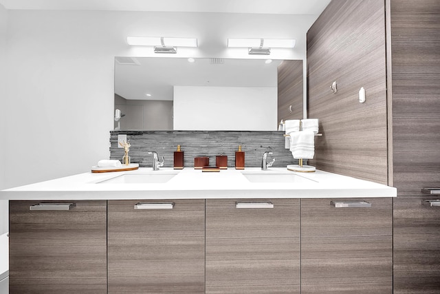 bathroom with double vanity and backsplash