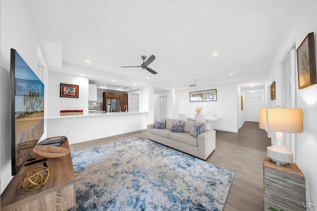 living room featuring ceiling fan, recessed lighting, and wood finished floors