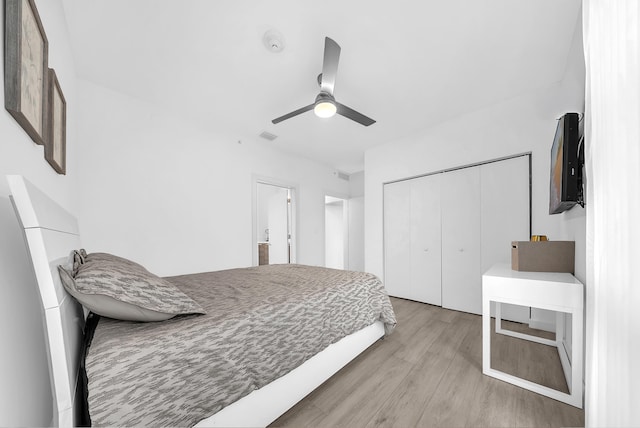 bedroom with wood finished floors, a closet, and a ceiling fan