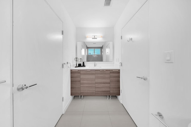 bathroom featuring vanity, tile patterned floors, and baseboards