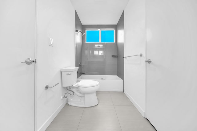 bathroom with baseboards, toilet, tile patterned floors, and shower / bathtub combination