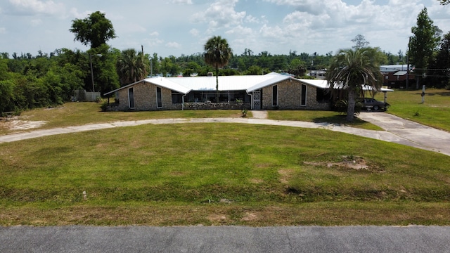 4832 Flynt Dr, Marianna, FL 32446 - view of front of property featuring curved driveway, stone siding, and a front yard