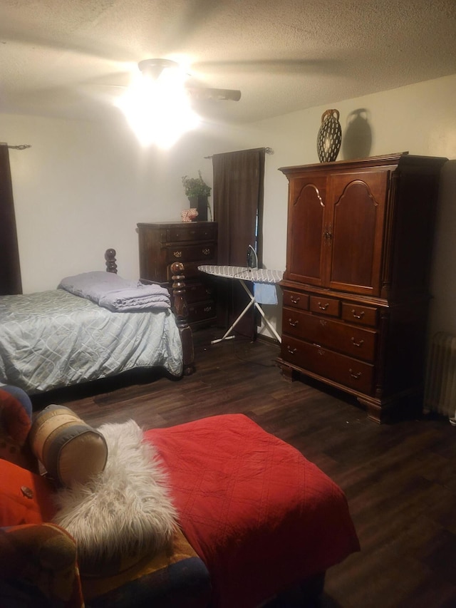 4832 Flynt Dr, Marianna, FL 32446 - bedroom with radiator, dark wood-style flooring, and a textured ceiling