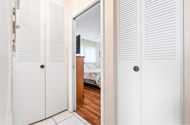 hall with light tile patterned floors