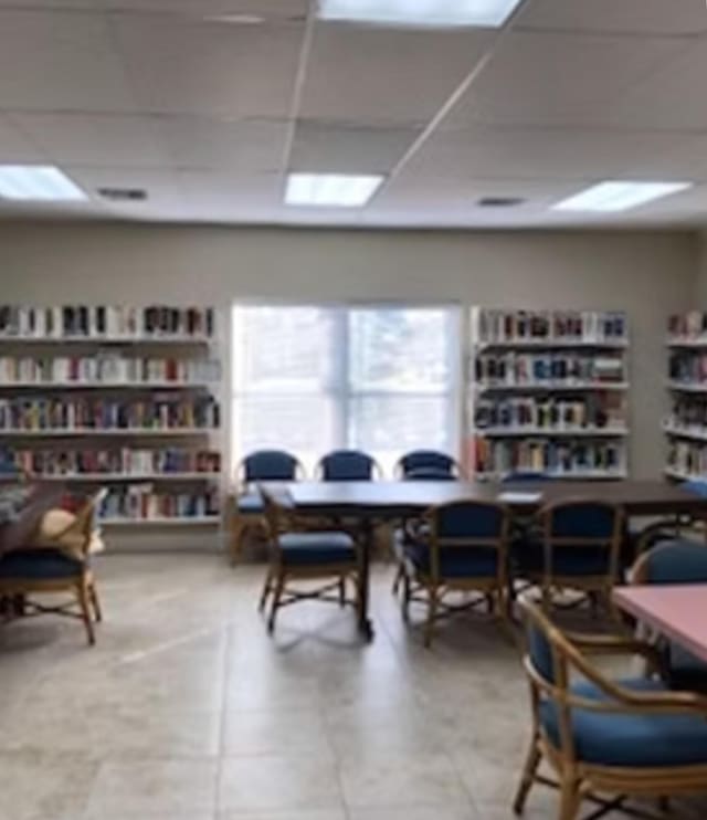 office space featuring a drop ceiling and tile patterned flooring