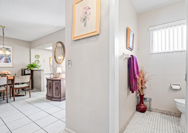 bathroom featuring tile patterned floors, toilet, vanity, and baseboards