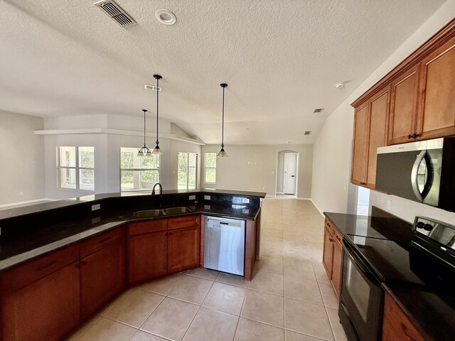 1744 SW Nantucket Ave, Port Saint Lucie, FL 34953 - kitchen with stainless steel appliances, a sink, open floor plan, hanging light fixtures, and light tile patterned floors