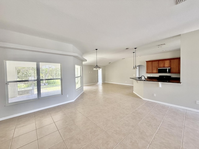 1744 SW Nantucket Ave, Port Saint Lucie, FL 34953 - unfurnished living room featuring light tile patterned floors, lofted ceiling, baseboards, a chandelier, and a sink