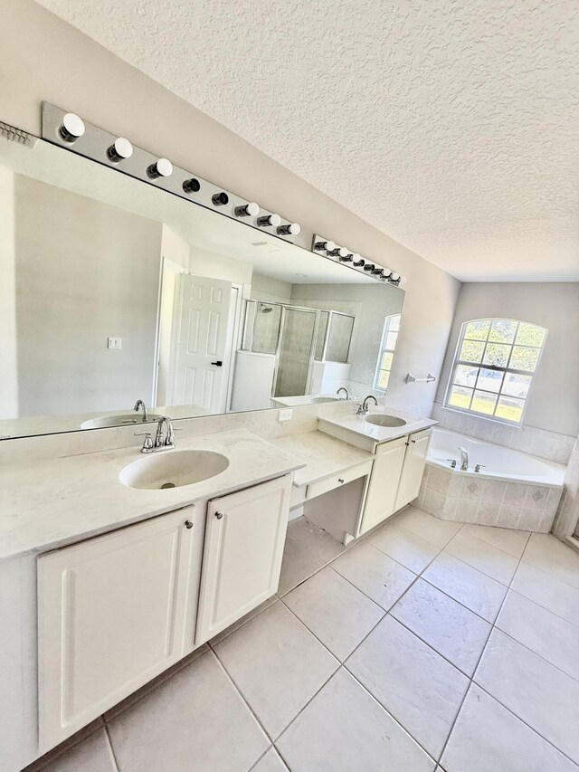 1744 SW Nantucket Ave, Port Saint Lucie, FL 34953 - bathroom featuring a textured ceiling, tile patterned flooring, a garden tub, a stall shower, and two vanities