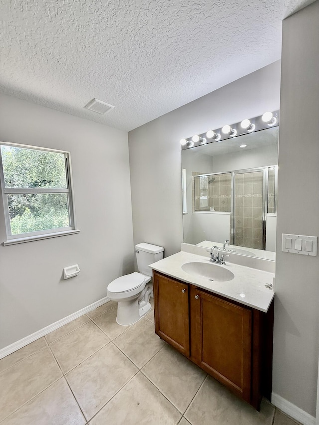 1744 SW Nantucket Ave, Port Saint Lucie, FL 34953 - bathroom featuring a shower stall, vanity, toilet, tile patterned flooring, and baseboards