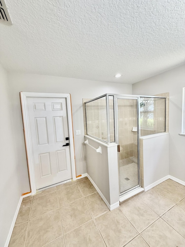 1744 SW Nantucket Ave, Port Saint Lucie, FL 34953 - bathroom with tile patterned floors, a shower stall, a textured ceiling, baseboards, and recessed lighting