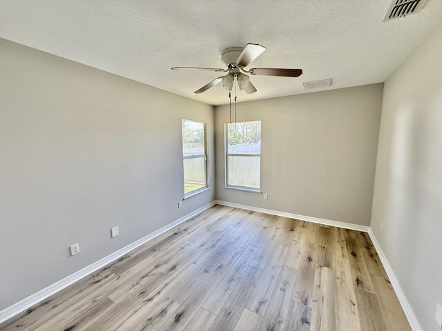 1744 SW Nantucket Ave, Port Saint Lucie, FL 34953 - spare room featuring a ceiling fan, light wood-style floors, baseboards, and a textured ceiling