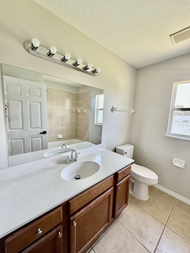 1744 SW Nantucket Ave, Port Saint Lucie, FL 34953 - full bathroom with tile patterned flooring, vanity, toilet, a textured ceiling, and tiled shower
