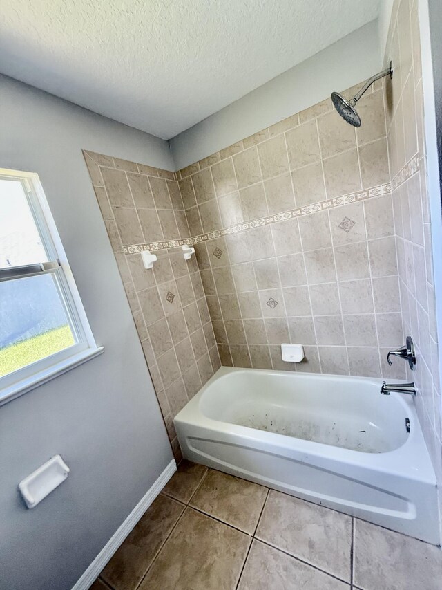 1744 SW Nantucket Ave, Port Saint Lucie, FL 34953 - bathroom featuring tile patterned floors, shower / bath combination, baseboards, and a textured ceiling