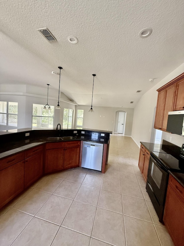 1744 SW Nantucket Ave, Port Saint Lucie, FL 34953 - kitchen featuring a sink, appliances with stainless steel finishes, dark countertops, a textured ceiling, and light tile patterned floors