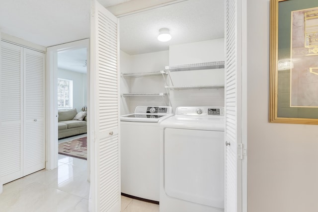 6698 10th Ave N Unit 320, Lake Worth, FL 33467 - laundry area featuring washing machine and dryer and light tile patterned flooring