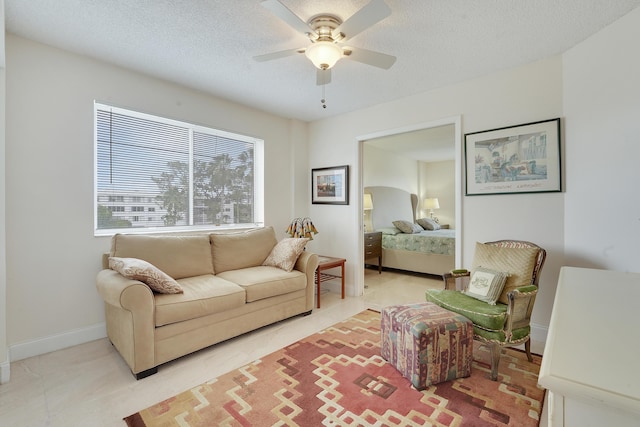 6698 10th Ave N Unit 320, Lake Worth, FL 33467 - living room with a ceiling fan, baseboards, and a textured ceiling