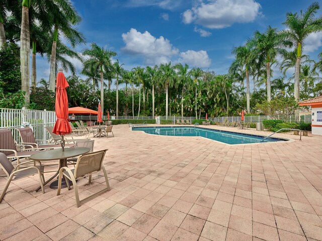 9564 Crescent View Dr N, Boynton Beach, FL 33437 - community pool with fence and a patio