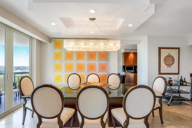 901 E Camino Real Unit 7C, Boca Raton, FL 33432 - dining space with a chandelier, recessed lighting, and a tray ceiling