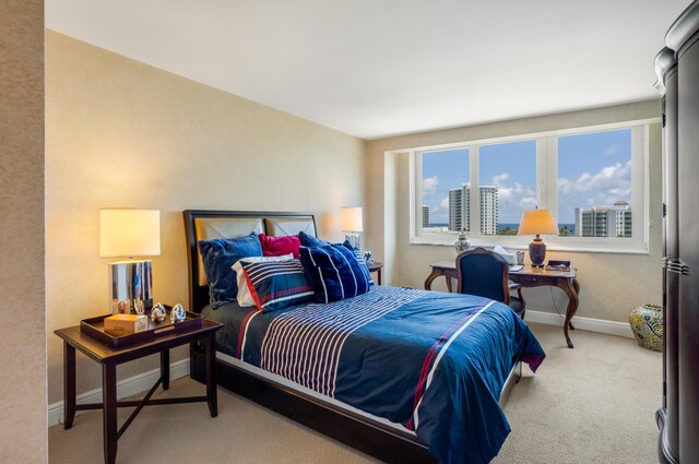 901 E Camino Real Unit 7C, Boca Raton, FL 33432 - carpeted bedroom featuring baseboards