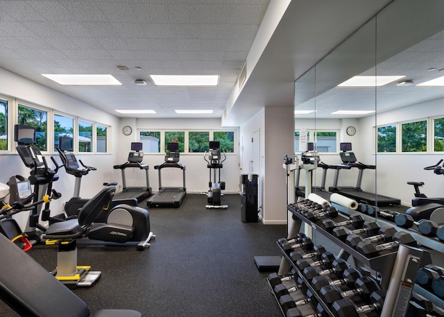 901 E Camino Real Unit 7C, Boca Raton, FL 33432 - exercise room with healthy amount of natural light, a drop ceiling, and baseboards