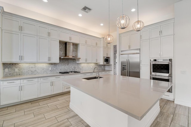16323 Pantheon Pass, Delray Beach, FL 33446 - kitchen with built in appliances, a sink, wall chimney exhaust hood, a chandelier, and backsplash