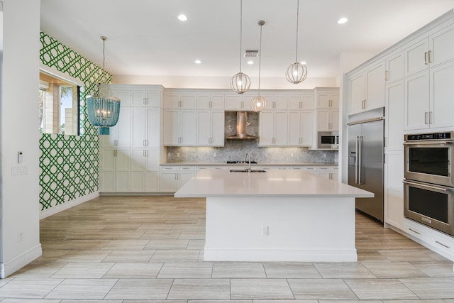 16323 Pantheon Pass, Delray Beach, FL 33446 - kitchen featuring built in appliances, wall chimney exhaust hood, a sink, light countertops, and tasteful backsplash