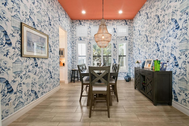 16323 Pantheon Pass, Delray Beach, FL 33446 - dining room featuring wallpapered walls, a chandelier, baseboards, recessed lighting, and wood finish floors
