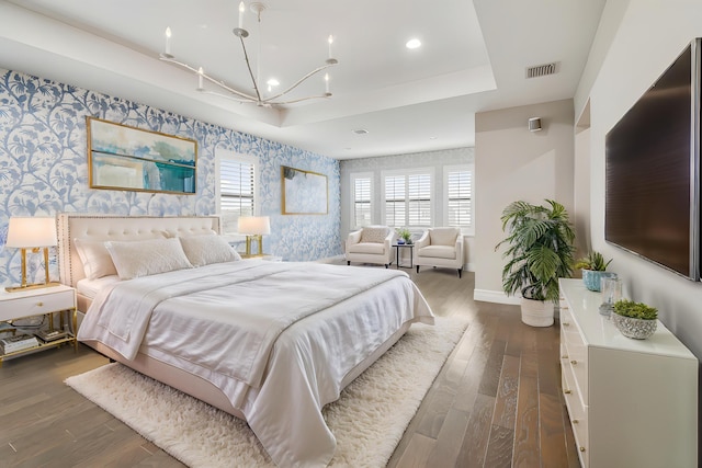 16323 Pantheon Pass, Delray Beach, FL 33446 - bedroom featuring wallpapered walls, baseboards, a chandelier, an accent wall, and dark wood-style flooring