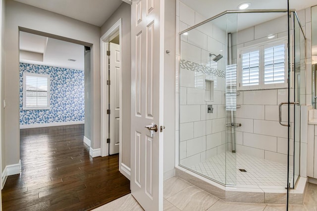 16323 Pantheon Pass, Delray Beach, FL 33446 - bathroom featuring baseboards, wood finished floors, wallpapered walls, and a stall shower