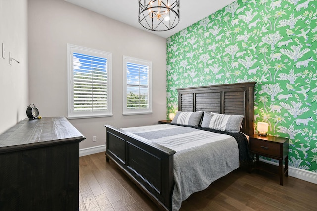 16323 Pantheon Pass, Delray Beach, FL 33446 - bedroom with wallpapered walls, baseboards, an accent wall, dark wood finished floors, and a chandelier