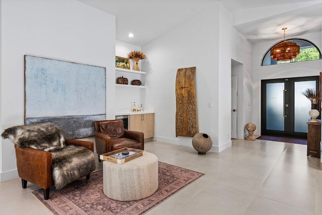 1175 Sea Grape Cir, Delray Beach, FL 33445 - living area featuring high vaulted ceiling, bar area, baseboards, built in features, and light tile patterned floors