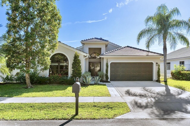 1175 Sea Grape Cir, Delray Beach, FL 33445 - mediterranean / spanish house featuring a garage, driveway, stucco siding, and a front lawn