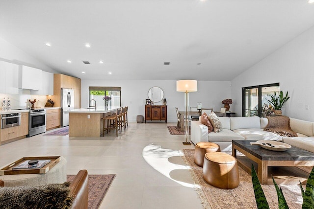 1175 Sea Grape Cir, Delray Beach, FL 33445 - living area with lofted ceiling, light tile patterned flooring, and recessed lighting