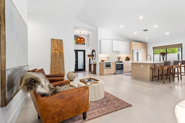 1175 Sea Grape Cir, Delray Beach, FL 33445 - living room featuring lofted ceiling, recessed lighting, and light tile patterned floors