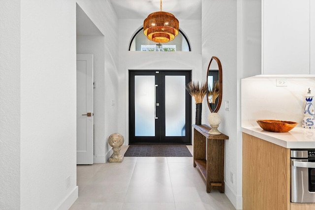 1175 Sea Grape Cir, Delray Beach, FL 33445 - tiled entryway featuring baseboards and a towering ceiling