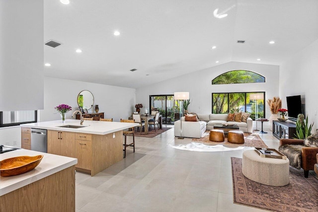1175 Sea Grape Cir, Delray Beach, FL 33445 - kitchen featuring a sink, open floor plan, vaulted ceiling, light countertops, and an island with sink