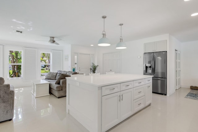 kitchen with stainless steel refrigerator with ice dispenser, light tile patterned floors, recessed lighting, ceiling fan, and light countertops