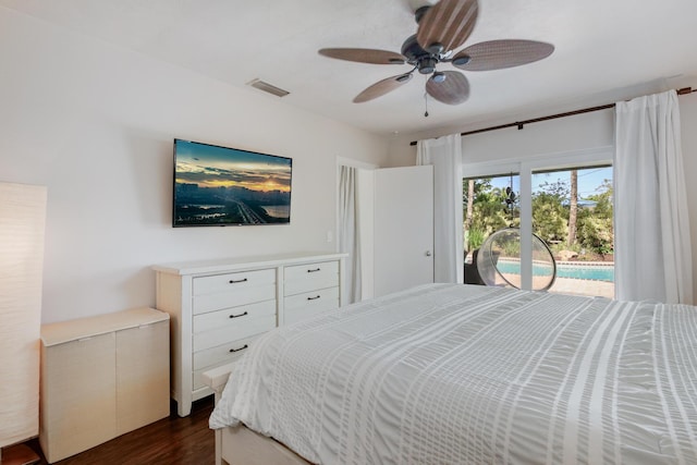 bedroom with access to outside, dark wood finished floors, and a ceiling fan